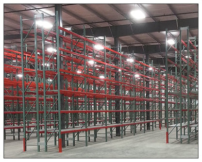 Unirak teardrop-style pallet rack system built from green Unirak upright frames with orange load beams in a warehouse