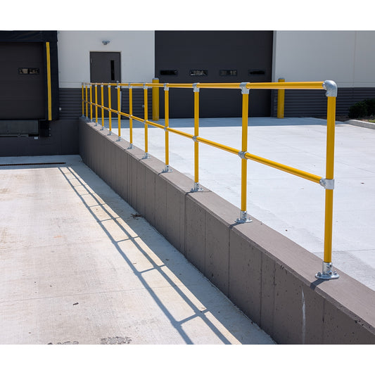 Save-ty Yellow modular steel handrail along a loading dock wall
